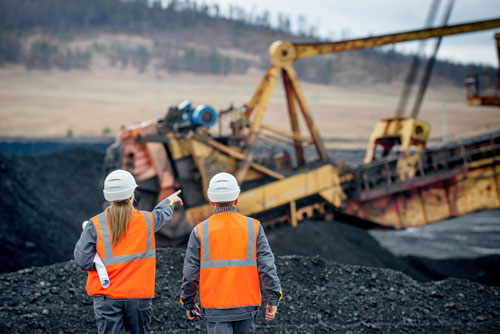 two workers in an open pit mine